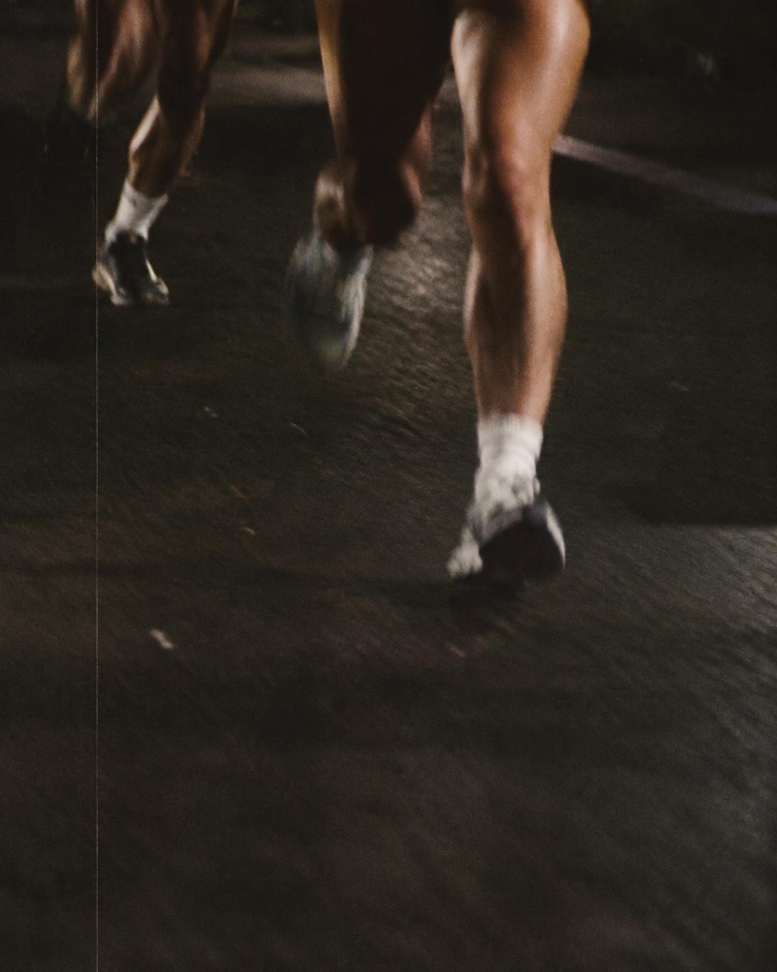 Runners in motion on asphalt, gritty 16mm film style
